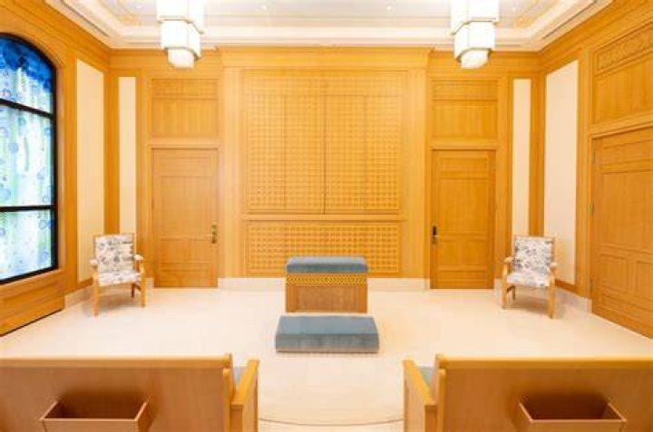 An instruction room inside the St. George Utah Temple with murals on the walls.