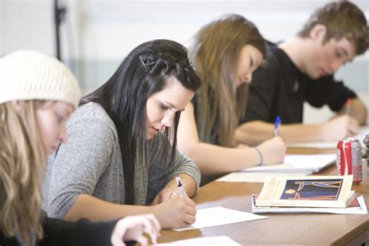 Snow College students take notes on their phones during a devotional with Elder David A. Bednar.