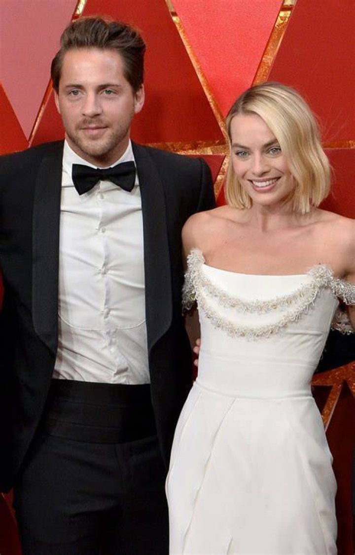 Tom Ackerley and Margot Robbie attends the 96th Annual Academy Awards